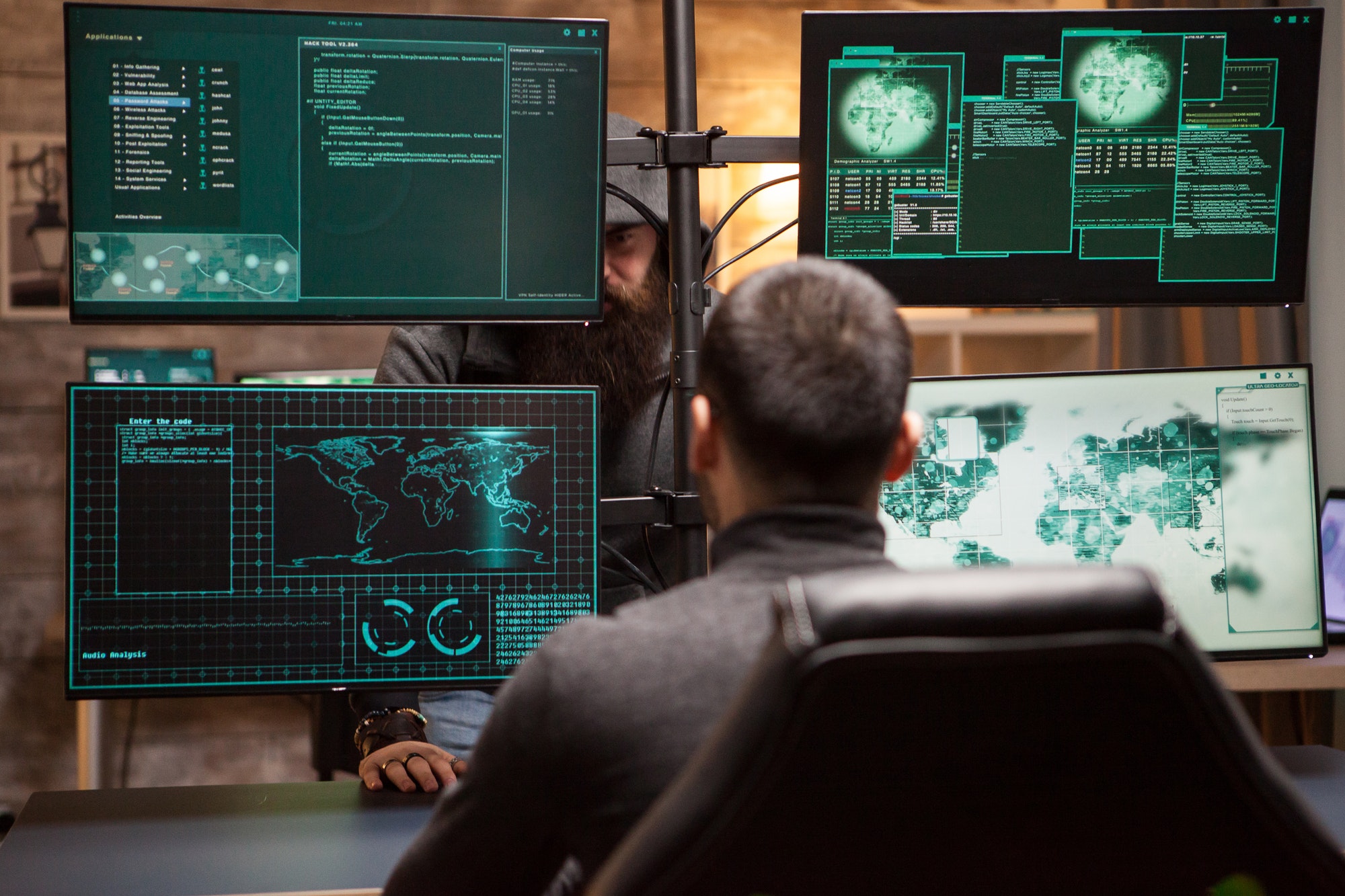 bearded-old-hacker-wearing-a-hoodie-talking-with-young-hacker.jpg